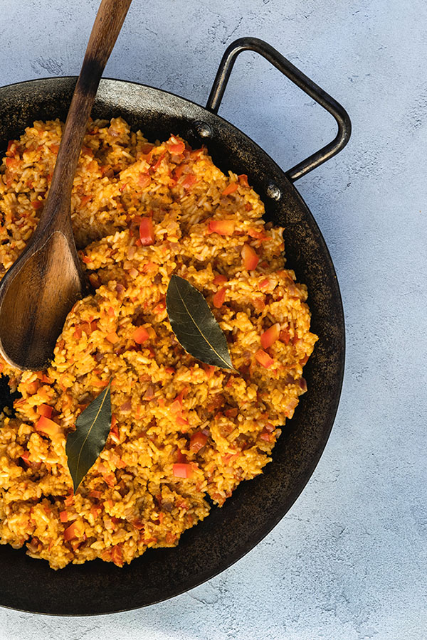 Ugandan Rice photographed for the Medley newsletter with a wood spoon in a black iron paella pan. Minneapolis Food Photographers. Food photography, product photography, lifestyle photography, blogger photographer, influencer photographer, social media photographer, commercial photography, branding photographer