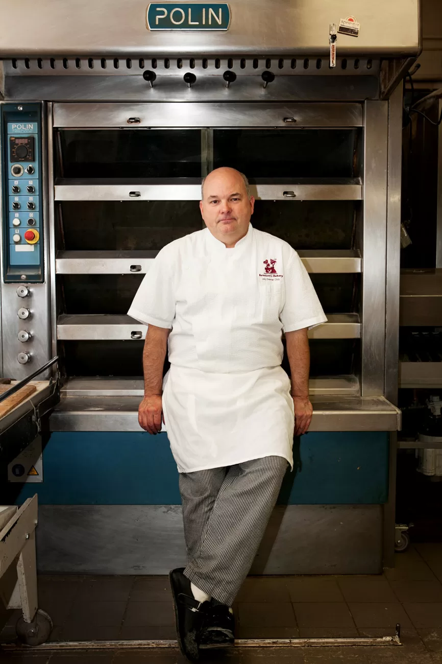 Pastry Chef Jory Downer poses for an Editorial Portrait in front of an industrial bread oven at Bennison's Bakery in Evanston, Illinois.