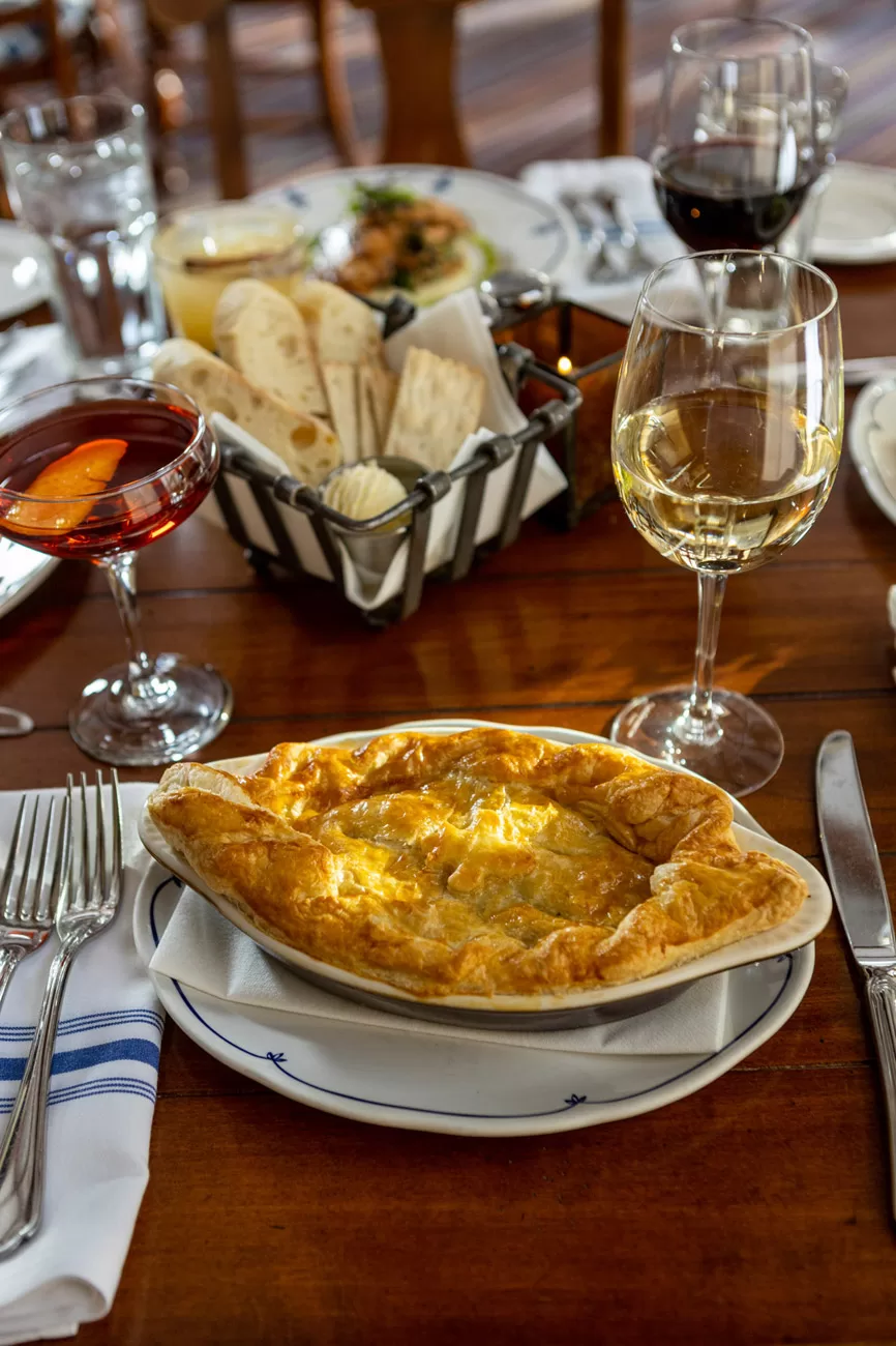 Chicken pot pie entree set on a restaurants dining room table in a lifestyle scene