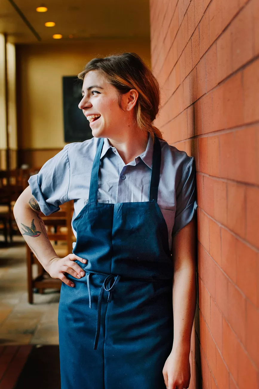 Publican Restaurant dining room in downtown Chicago. Candid editorial environmental Portrait of the restaurants pastry Chef laughing.